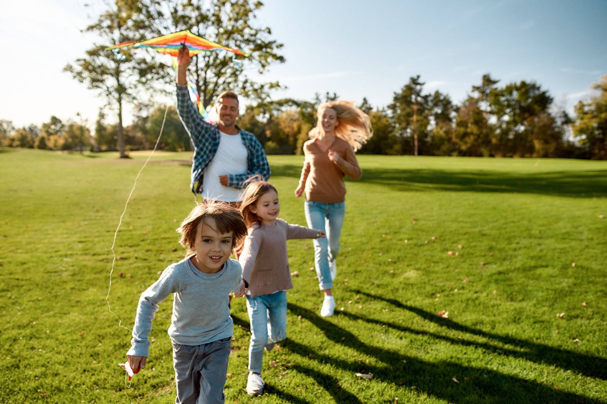 There are no words to describe how special kids are. Happy family playing a kite. Outdoor family weekend There are no words to describe how special kids are. Happy family playing a kite. Outdoor family weekend