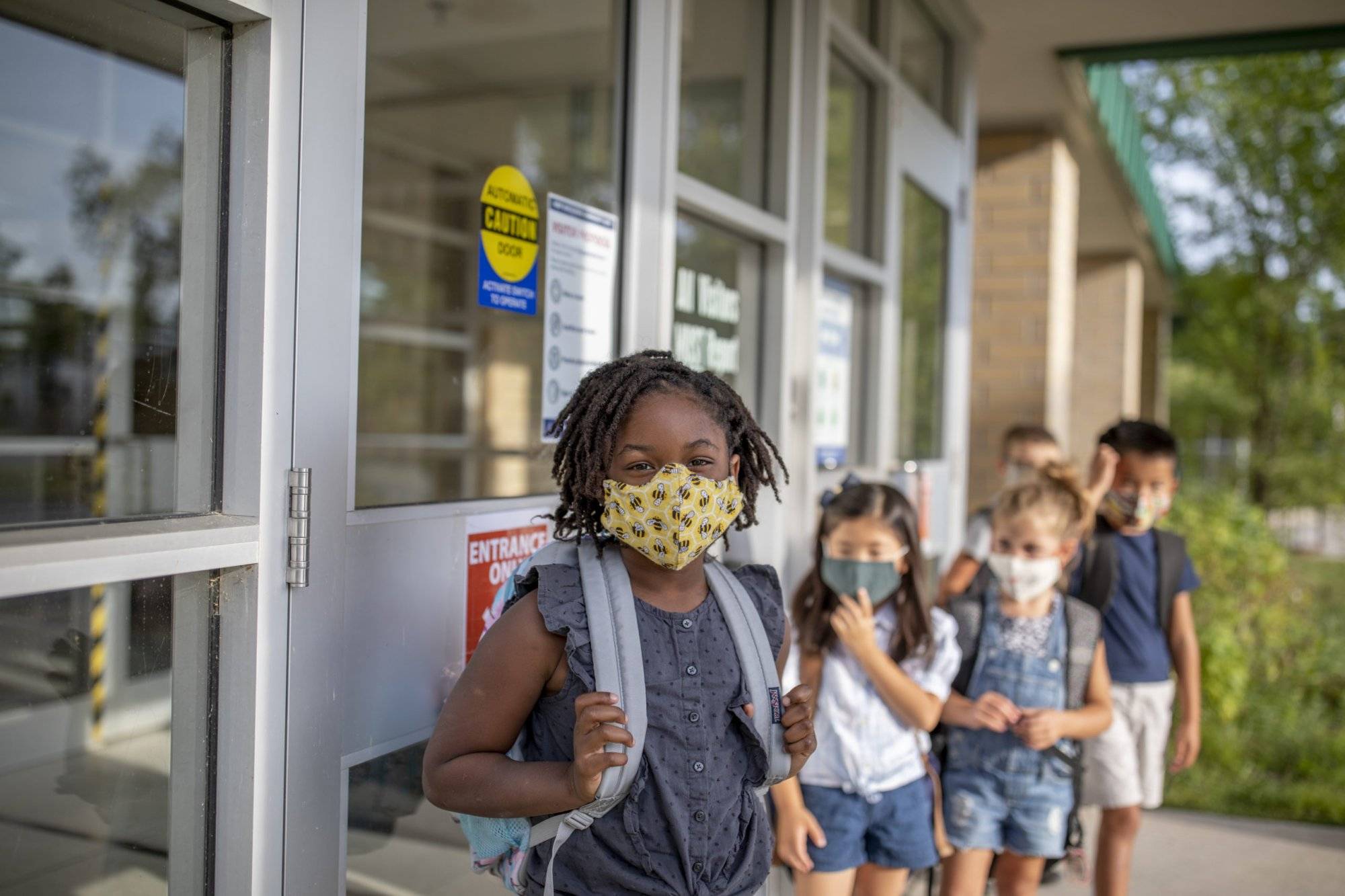 Diverse group of elementary school kids go back to school wearing masks Diverse group of elementary school kids go back to school wearing masks
