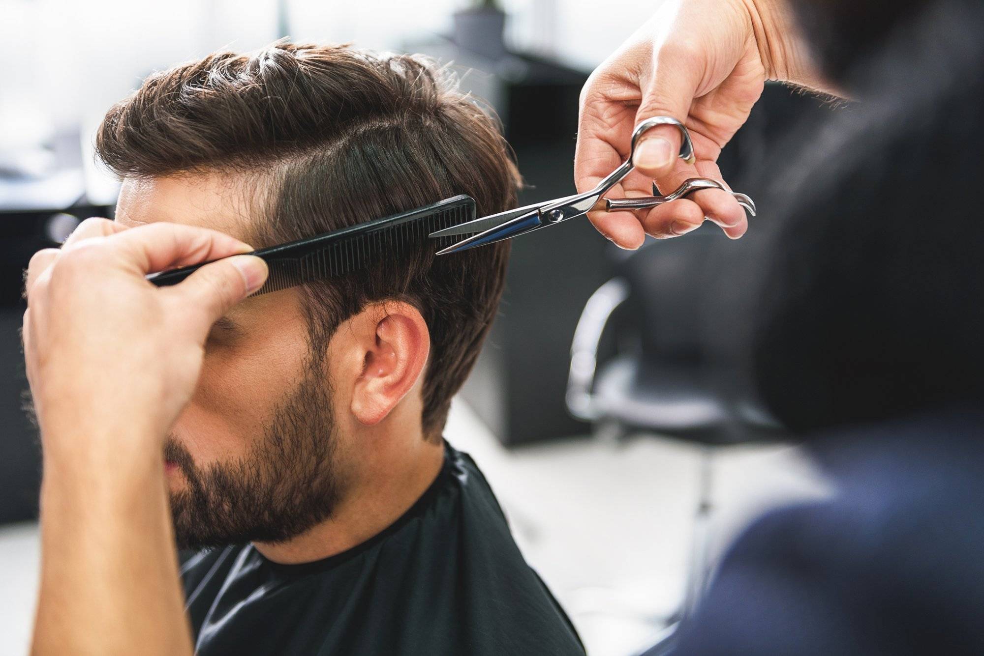 Barber using scissors and comb Barber using scissors and comb