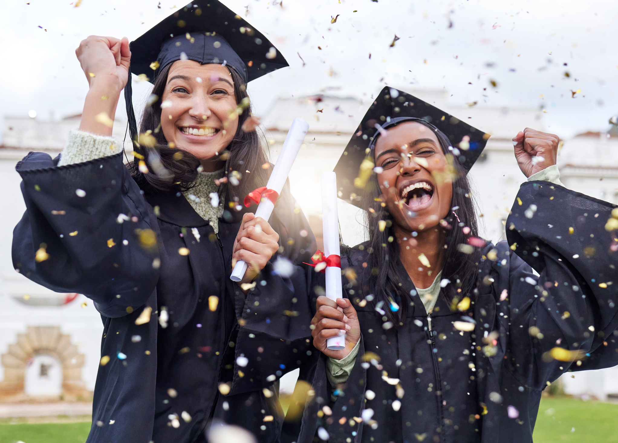 Cropped portrait of two attractive young female students celebrating on graduation day