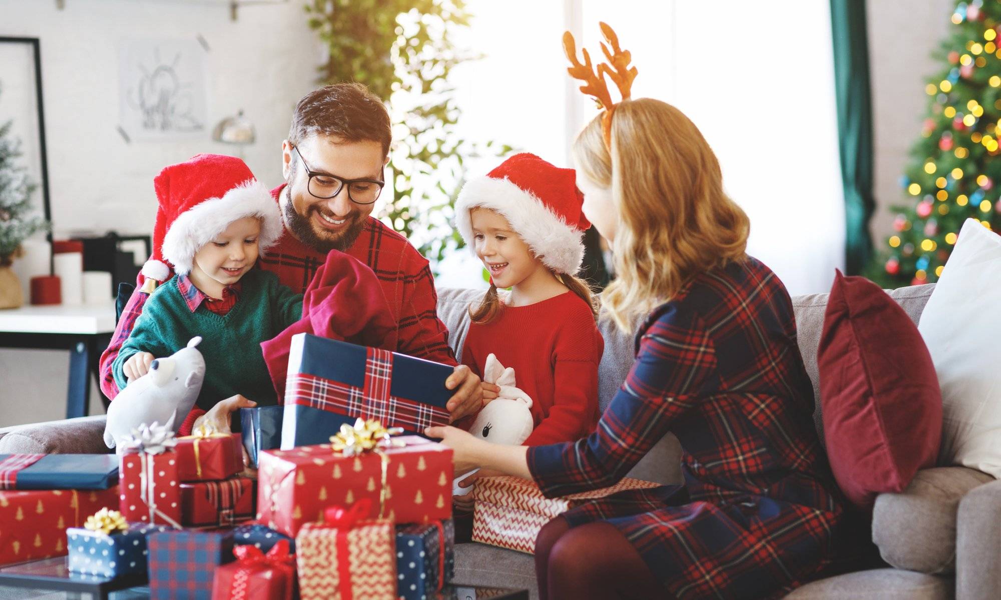happy family open presents on Christmas morning Discover the Ultimate Holiday Gift Guide in Arlington at Fielder Plaza